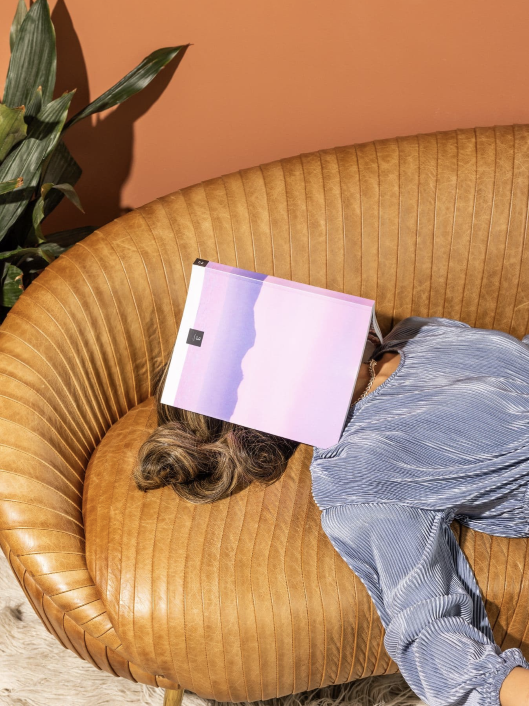 Person sprawled across a leather sofa